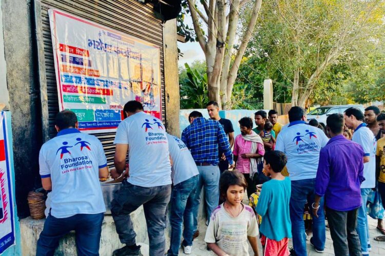 Bharosa volunteers carrying ration kits to remote villages